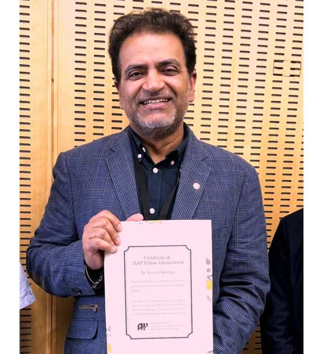 photo of kaustav banerjee w/ award